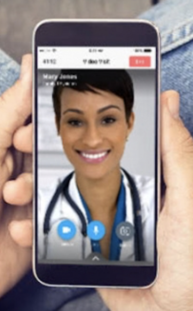 A person holding up their phone to take a picture of a doctor.